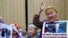 KYRGYZSTAN -- A supporter of Kyrgyz former President Almazbek Atambaev gestures as she attends a rally outside the State Committee for National Security, where the court hears an appeal by lawyers of Atambaev, in Bishkek, August 16, 2019